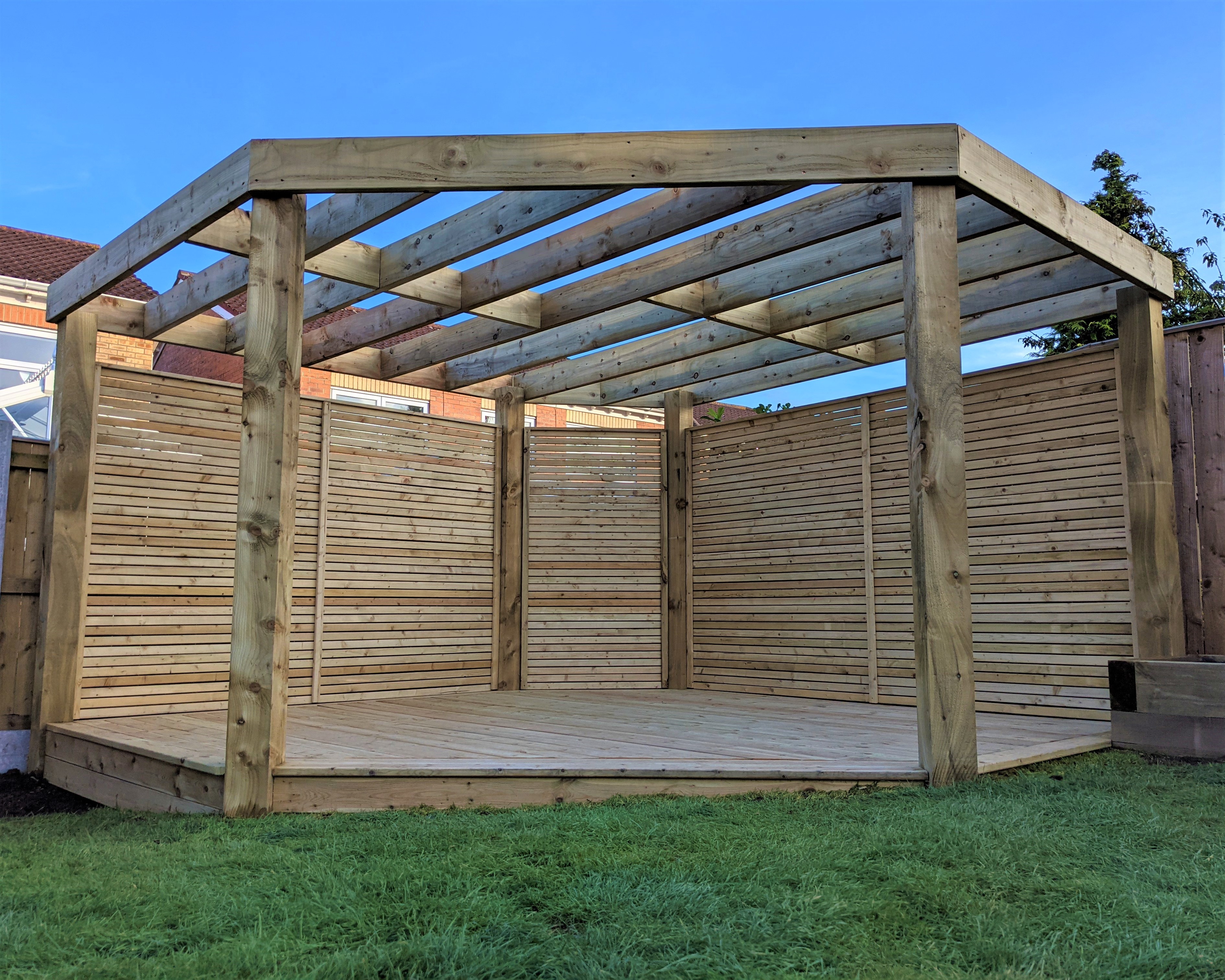One of the many Pergolas from Instyle and Design. This is a wooden Pergola on a grass garden.
